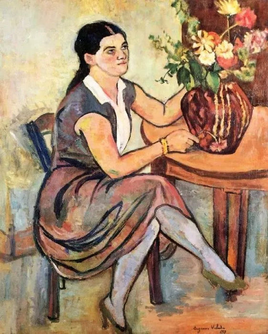 WOMAN SEATED BY A BOUQUET OF FLOWERS