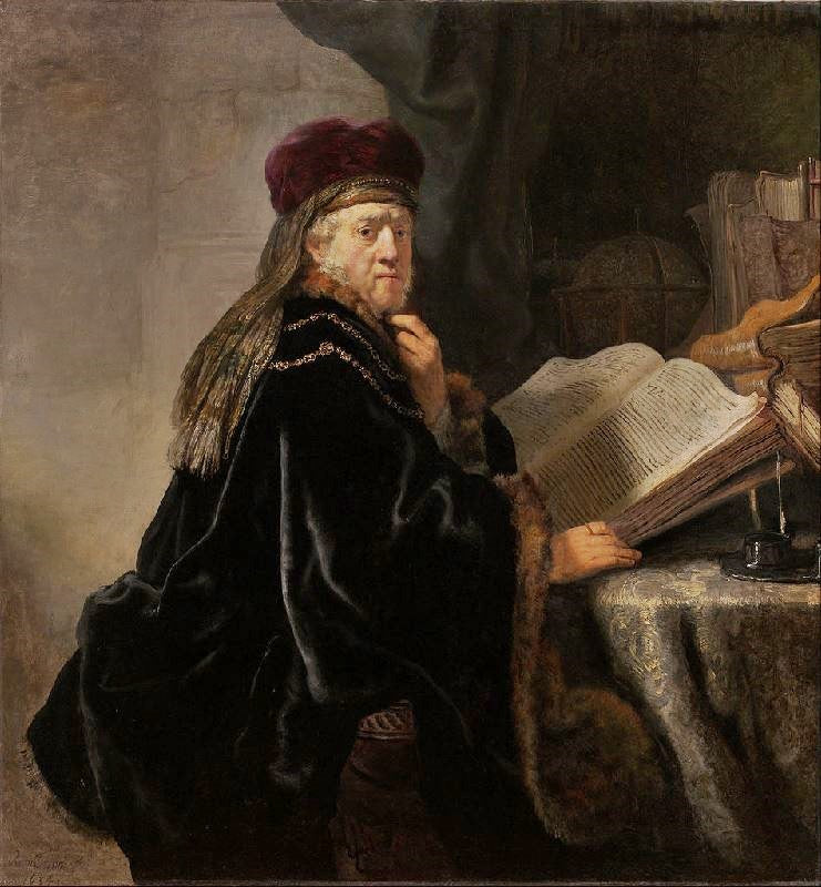 A Scholar Seated At A Desk With His Books by Rembrandt van Rijn