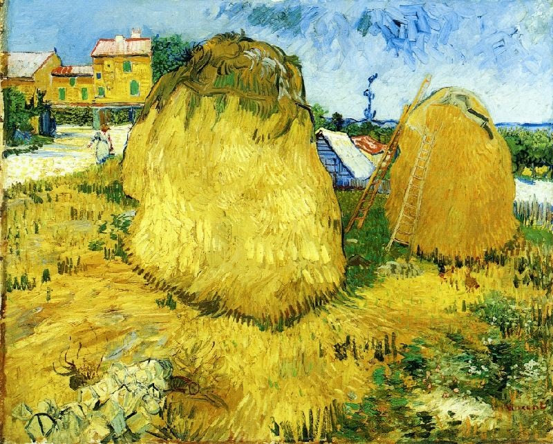 STACKS OF WHEAT NEAR A FARMHOUSE