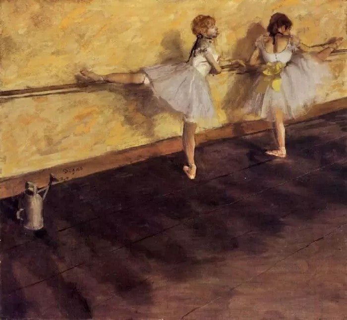 DANCERS PRACTICING AT THE BARRE